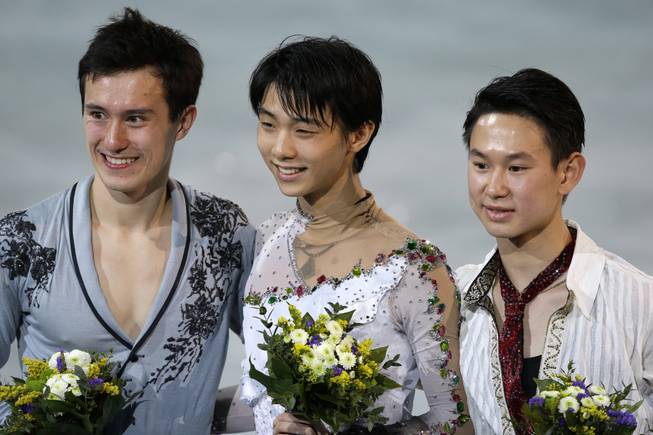Patrick Chan of Canada, Yuzuru Hanyu of Japan and Denis Ten of Kazakhstan stand on the podium during the medal ceremony for the men's free skate figure skating final at Iceberg Skating Palace during the 2014 Winter Olympics, Friday, Feb. 14, 2014, in Sochi, Russia.