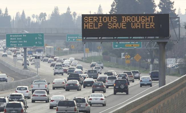 In this photo taken Wednesday, Feb. 12, 2014, a sign on westbound Highway 50 in Sacramento,  normally used to warn drivers of traffic problems or display Amber Alert messages, displays a message to conserve water due to California's drought. Gov. Jerry Brown was governor the last time California had a drought of epic proportions, in 1975-76, and now is pushing a controversial $25 billion plan to build twin tunnels to ship water from the Sacramento-San Joaquin River Delta to farmland and cities further south.