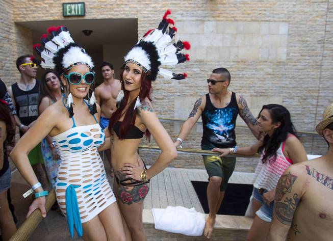 Angel Alcantar and Kylie Doughman wear Indian headdresses during the Halfway to EDC and first winter pool party at Marquee Dayclub on Sunday, Feb. 16, 2014, in the Cosmopolitan of Las Vegas.
