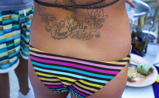 A woman sports an inspirational tattoo during the Halfway to EDC and first winter pool party at Marquee Dayclub on Sunday, Feb. 16, 2014, in the Cosmopolitan of Las Vegas.