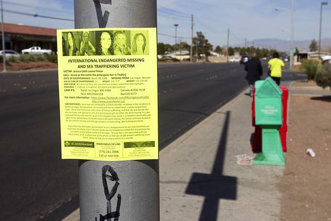 Volunteers Edward Cotton, left, and Maria Brezinski, post fliers on missing woman Jessie Foster on Jones Boulevard and Tropicana Avenue Monday, Feb. 17, 2014. Foster, a Canadian, went missing from North Las Vegas in 2006.