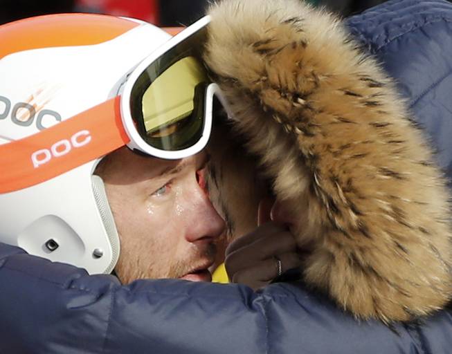 Men's super-G joint bronze medal winner Bode Miller of the United States is consoled by his wife, Morgan, at the Sochi 2014 Winter Olympics, Sunday, Feb. 16, 2014, in Krasnaya Polyana, Russia.