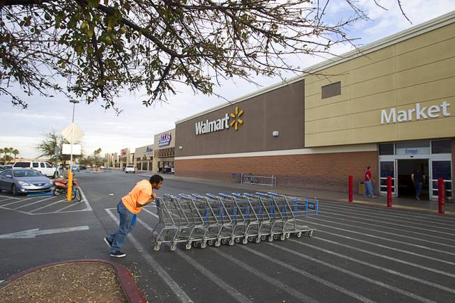 An employee gathers carts at the Walmart Supercenter at 3075 E Tropicana Ave. Tuesday, Feb. 18, 2014. The shopping center had been decline during the recession but is now recovering and adding tenants.