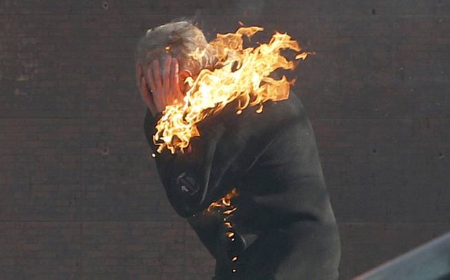 An anti-government protester is engulfed in flames during clashes with riot police outside Ukraine's parliament in Kiev, Ukraine, Tuesday, Feb. 18, 2014. 