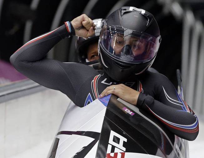 The team from the United States USA-1, piloted by Elana Meyers with brakeman Lauryn Williams, brake in the finish area after their second run during the women's two-man bobsled competition at the 2014 Winter Olympics, Tuesday, Feb. 18, 2014, in Krasnaya Polyana, Russia.