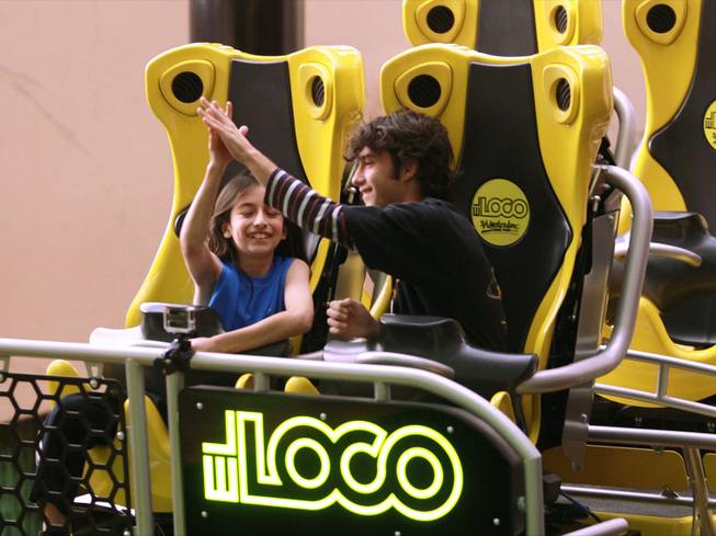 Benjamin de los Santos, left, and Chris McKenna high five after being the first to ride the El Loco roller coaster at Circus Circus Tuesday, Feb. 18, 2014.
