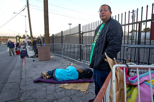 Mike Lora, 33, an unemployed tradesman, waits on Foremaster Lane Wednesday, Feb. 19, 2014. Citing traffic issues on Main Street and Foremaster Lane, Metro Police are considering ways to ease traffic congestion, such as by designating areas for people to make donations to the homeless.