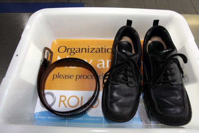 In this Wednesday, Jan. 10, 2007, file photo, a belt and shoes sit in a trays used in the safety screening of travelers done by the Transportation Security Administration, at the Los Angeles International Airport.