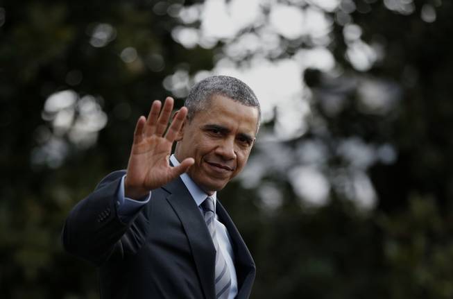 President Barack Obama waves to reporters as he walks on the South Lawn of the White House in Washington, Wednesday, Feb. 19, 2014, before boarding the Marine One helicopter to Andrews Air Force Base, Md., for his trip to Mexico.