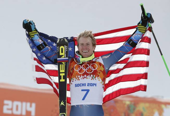 Men's giant slalom gold medalist Ted Ligety of the United States poses for photographers on the podium at the Sochi 2014 Winter Olympics, Wednesday, Feb. 19, 2014, in Krasnaya Polyana, Russia.