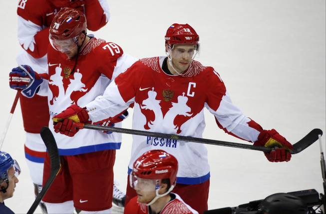 Russia defenseman Andrei Markov, left, and forward Pavel Datsyuk react after Russia lost 3-1 to Finland in a men's quarterfinal ice hockey game at the 2014 Winter Olympics, Wednesday, Feb. 19, 2014, in Sochi, Russia.