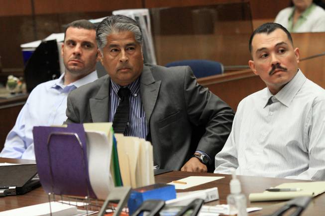 In this May 31, 2012, file photo, Marvin Norwood , left, with attorney Victor Escobedo, center, and co-defendant Louie Sanchez appear during a preliminary hearing held in Los Angeles Superior court. The two men pleaded guilty on Thursday, Feb. 20, 2014, in Los Angeles to a 2011 beating at Dodger Stadium that left San Francisco Giants fan Bryan Stow brain damaged and disabled.