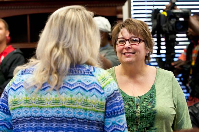 Becky Mintz, a heart recipient of another donor, visits with a friend while attending a ceremony celebrating the life of 16-year-old Aric Michael Brill, who donated six organs following his homicide five years ago, at the UMC Transplant Center Friday, February 21, 2014.