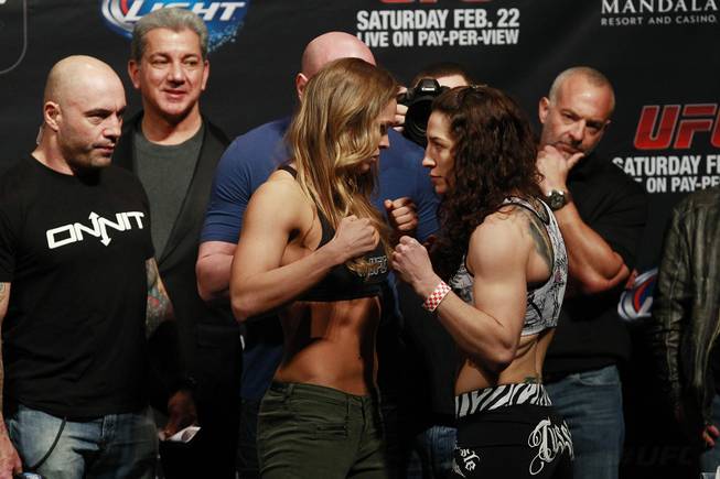 Bantamweight champion Ronda Rousey and challenger Sara McMann face off during the weigh in for UFC 170 Friday, Feb. 21, 2014 at the Mandalay Bay Events Center.