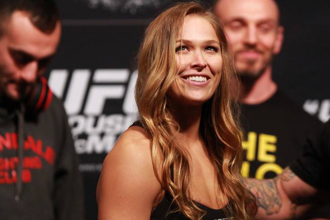 Bantamweight champion Ronda Rousey smiles during the weigh in for UFC 170 Friday, Feb. 21, 2014 at the Mandalay Bay Events Center.