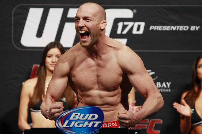Light heavyweight Patrick Cummins flexes after making weight during the weigh in for UFC 170 Friday, Feb. 21, 2014 at the Mandalay Bay Events Center.