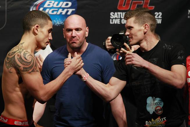 Robert Whittaker and Stephen Thompson shake hands after facing off during the weigh in for UFC 170 Friday, Feb. 21, 2014 at the Mandalay Bay Events Center.