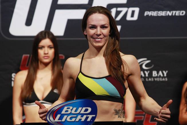 Alexis Davis poses after making weight during the weigh in for UFC 170 Friday, Feb. 21, 2014 at the Mandalay Bay Events Center.