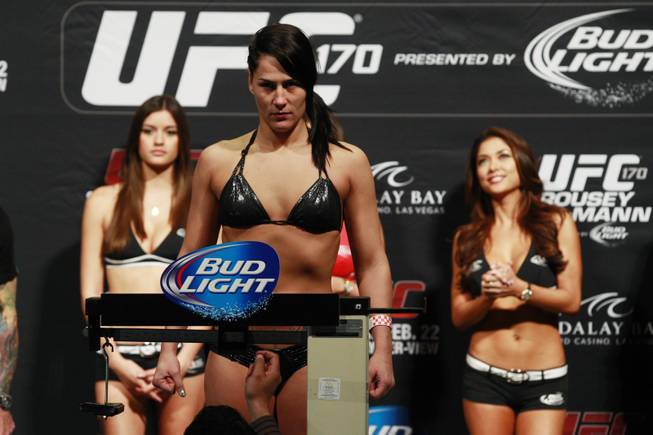Jessica Eye stands on the scale during the weigh in for UFC 170 Friday, Feb. 21, 2014 at the Mandalay Bay Events Center.