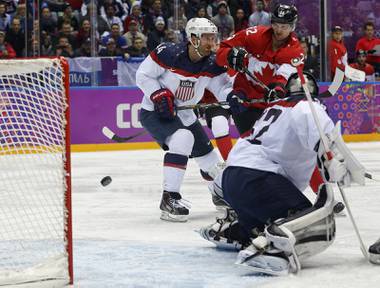 Canada forward Benn Jamie, right, shoots and scores against USA goaltender Jonathan Quick during the second period of a men’s semifinal ice hockey game at the 2014 Winter Olympics, Friday, Feb. 21, 2014, in Sochi, Russia. 