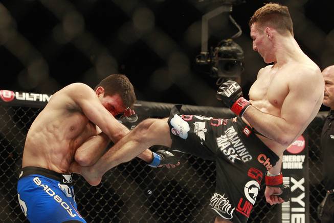 Rory MacDonald lands a kick to Demian Maia during their fight at UFC 170 Saturday, Feb. 22, 2014 at the Mandalay Bay Events Center.