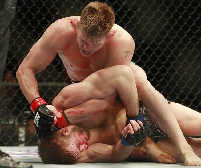 Mike Pyle pounds T.J. Waldburger into the mat during their fight at UFC 170 Saturday, Feb. 22, 2014 at the Mandalay Bay Events Center.