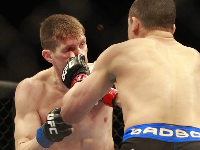 Stephen Thompson gets hit with a left from Robert Whittaker during their fight at UFC 170 Saturday, Feb. 22, 2014 at the Mandalay Bay Events Center.