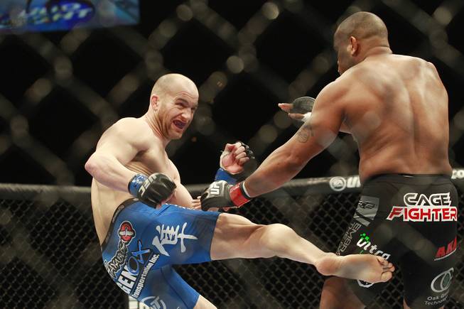 Patrick Cummins lands a kick to the leg of Daniel Cormier during their fight at UFC 170 Saturday, Feb. 22, 2014 at the Mandalay Bay Events Center. Cormier won by TKO in the first round.