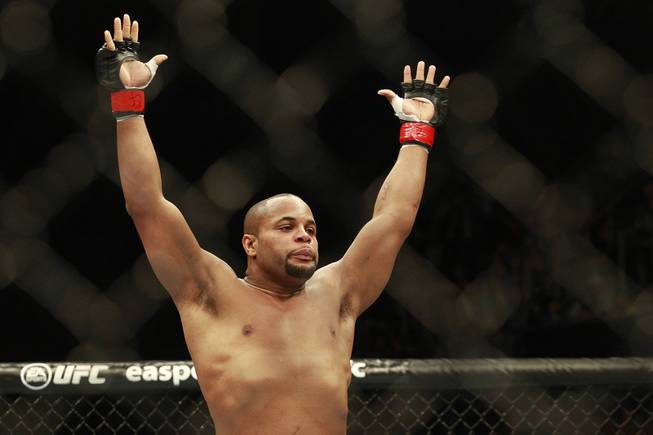 Daniel Cormier raises his arms after his first round TKO of Patrick Cummins during their fight at UFC 170 Saturday, Feb. 22, 2014 at the Mandalay Bay Events Center.