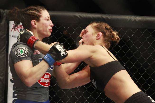 Sara McMann shoves Ronda Rousey's face during their fight at UFC 170 Saturday, Feb. 22, 2014 at the Mandalay Bay Events Center. Rousey won by TKO in the first round with a knee to the McMann's liver.