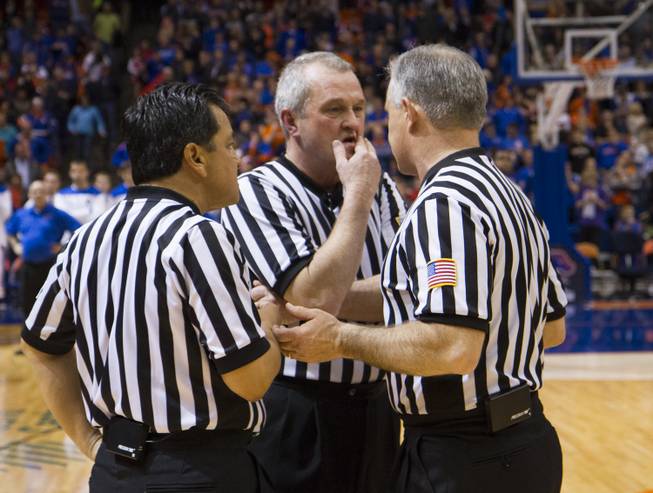 The referees confer during UNLV's 91-90 overtime loss to Boise State at Taco Bell Arena in Boise on Saturday, Feb. 22, 2014.