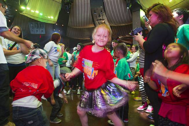 Alexis Neanover, center, 7, shows her moves on the dance floor during the second annual Dance Against Obesity Camp at the Marquee nightclub in the Cosmopolitan Las Vegas Sunday, Feb. 23, 2014. The free dance clinic was sponsored by TAO Cares and the Jump for Joy Foundation. While the children learned dance moves, parents participated in nutritional seminars.