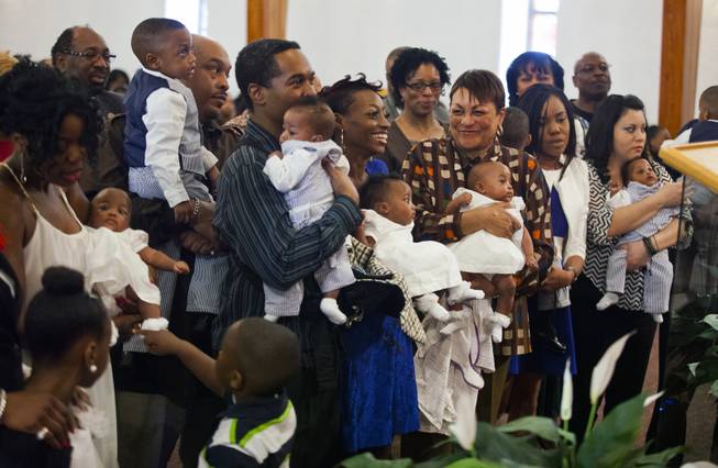 The Derrico family and friends gather near the alter at Victory Missionary Baptist Church as the quintuplets are welcomed to the church on Sunday, Feb. 23, 2014.
