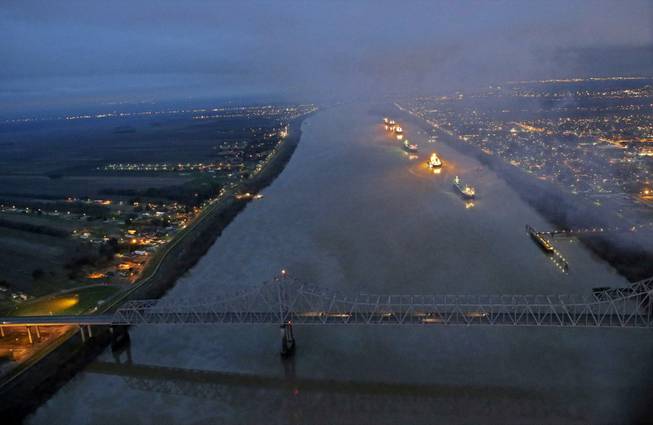 In this aerial photo, river traffic is halted along the Mississippi River between New Orleans and Vacherie, La., due to a barge leaking oil in St. James Parish, La., Sunday, Feb. 23, 2014. The collision happened Saturday afternoon near Vacherie, 47 miles west of New Orleans.