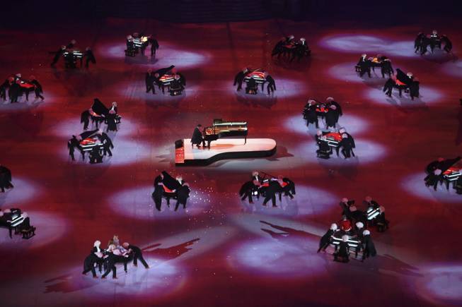 Pianist Denis Matsuev performs while pianos are moved around him during the closing ceremony for the 2014 Winter Olympics at Fisht Olympic Stadium in Sochi, Russia, Feb. 23, 2014. (Josh Haner/The New York Times)