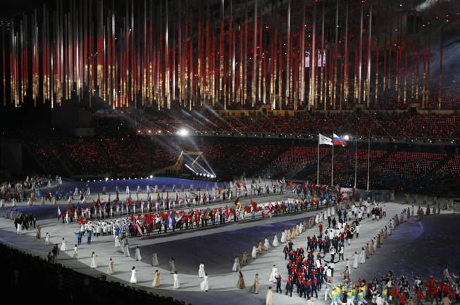 Athletes march into the arena during the closing ceremony of the 2014 Winter Olympics, Sunday, Feb. 23, 2014, in Sochi, Russia.