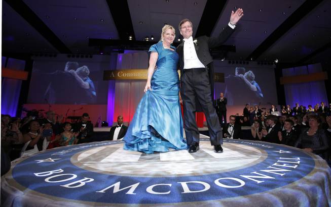In this Saturday, Jan. 16, 2010 file photo, Virginia Gov. Bob McDonnell waves to the crowd along with his wife, Maureen during his inaugural ball in Richmond, Va. The former first lady of Virginia and her husband, former Gov. Bob McConnell, have been indicted on several counts of trading on their influence to enrich themselves and family members.