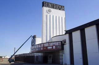 Workers hang a banner with a Huntridge logo at the Huntridge Theater at Maryland Parkway and Charleston Boulevard Monday, Feb. 24, 2014.