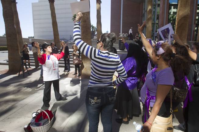 Community activist Rosemary Flores, left, leads people in chants during a rally to increase awareness of machete attack victim Maria Gomez outside Clark County Regional Justice Center Monday, Feb. 24, 2014. Armando Vergara-Martinez is accused in the attack.