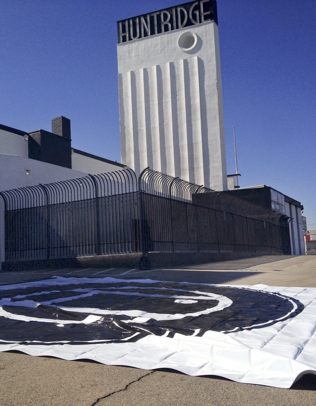 A banner with the new circle H logo of The Huntridge was hung from the building as part of the continued Huntridge revitalization efforts Monday, Feb. 24, 2014.