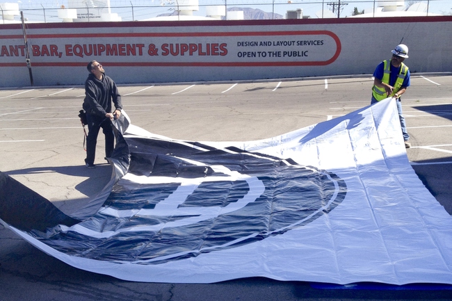 A banner with the new circle H logo of The Huntridge was hung from the building as part of the continued Huntridge revitalization efforts Monday, Feb. 24, 2014.