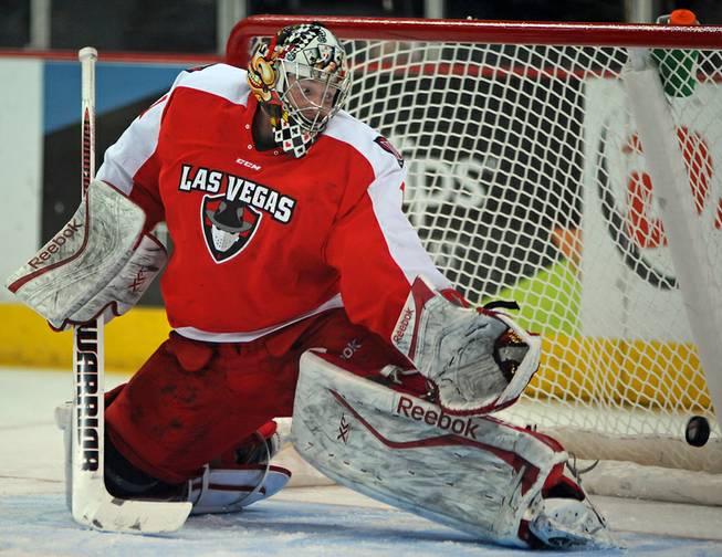 Las Vegas Wranglers goaltender Mitch O'Keefe watches as a Bakersfield Condors shot bounces off a post and into the back of his net during the first period of play on Tuesday night.