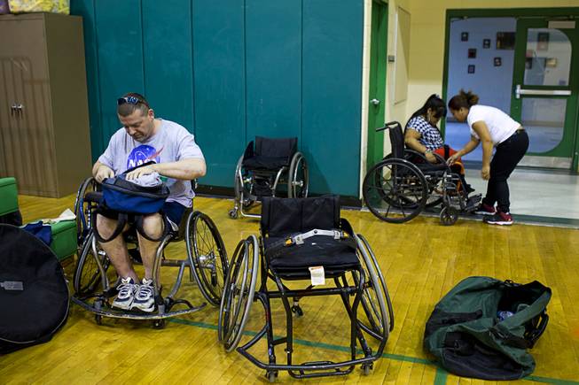 Marc Fenn prepares for a wheelchair basketball practice at Rancho High School Tuesday, Feb. 25, 2014. Fenn's team is practicing for a scrimmage against a Wounded Warriors team at Nellis Air Force Base on Thursday.