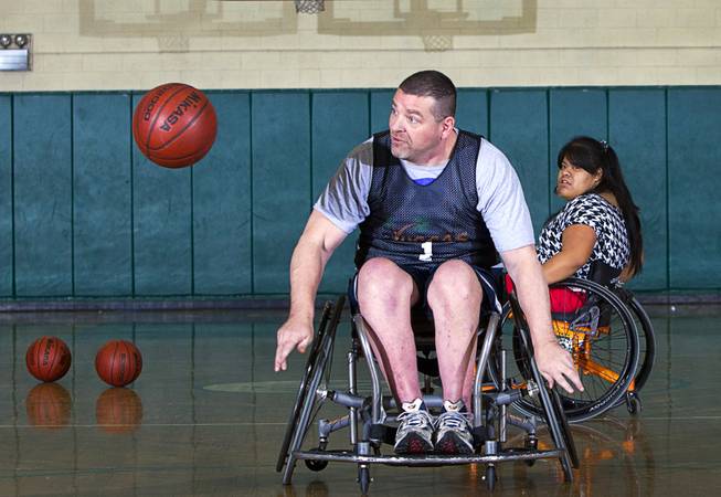 Marc Fenn chases after a loose ball during wheelchair basketball practice at Rancho High School Tuesday, Feb. 25, 2014. The team is practicing for a scrimmage against a Wounded Warriors team at Nellis Air Force Base on Thursday.