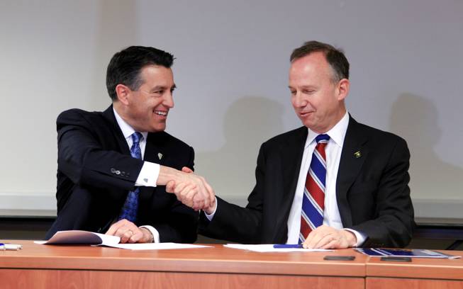 Nevada Gov. Brian Sandoval, left, and Delaware Gov. Jack Markell shake hands after signing the Multi-State Internet Gambling Agreement in the Delaware State Office Building in Wilmington Tuesday morning, Feb. 26, 2014.