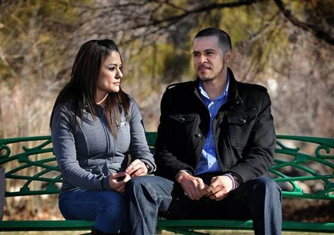 Liliana Reyes, left, and her husband, Jose Reyes sit and talk on a bench along the Truckee River in Reno, Nev. The parents, of a 12-year-old Sparks Middle School boy who shot and killed a teacher and wounded two students before turning the gun on himself in October 2013, have donated nearly $14,000 to an anti-bullying program in a partnership with the school district.