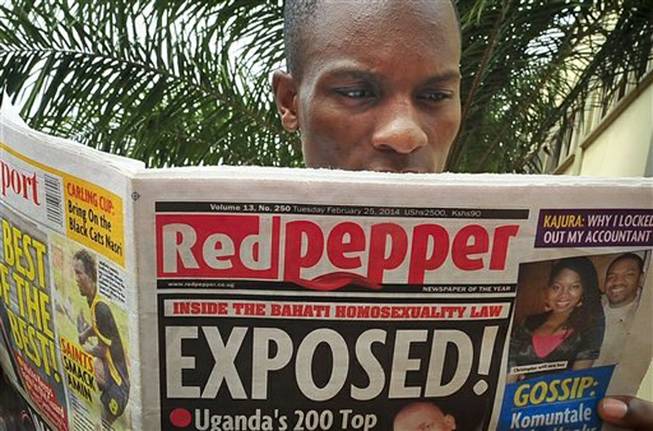 A Ugandan reads a copy of the Red Pepper tabloid newspaper in Kampala, Uganda Tuesday, Feb. 25, 2014. The Ugandan newspaper published a list Tuesday of what it called the country's "200 top" homosexuals, outing some Ugandans who previously had not identified themselves as gay, one day after Uganda President Yoweri Museveni enacted a harsh anti-gay law.