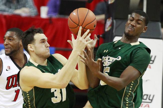 Colorado State forwards J.J. Avila and Gerson Santo ry to control a rebound during the first half of their Mountain West Conference game against UNLV Wednesday, Feb. 26, 2014 at the Thomas & Mack Center.