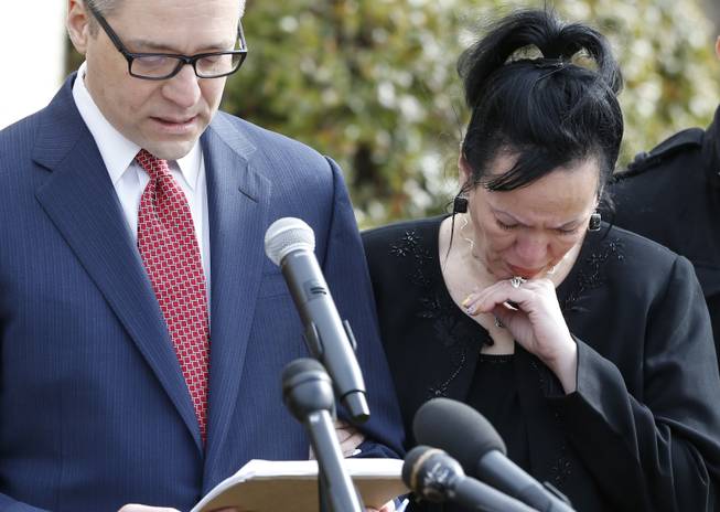 Attorney Michael Brooks-Jimenez, left, speaks at a news conference in Oklahoma City, Tuesday, Feb. 25, 2014. At right is Nair Rodriguez. At the news conference, the family of Luis Rodriguez, a man who died after a struggle with police outside an Oklahoma movie theater, released a cellphone video of the incident that shows the man on his stomach on the ground with five officers restraining him, including one officer holding his head down.