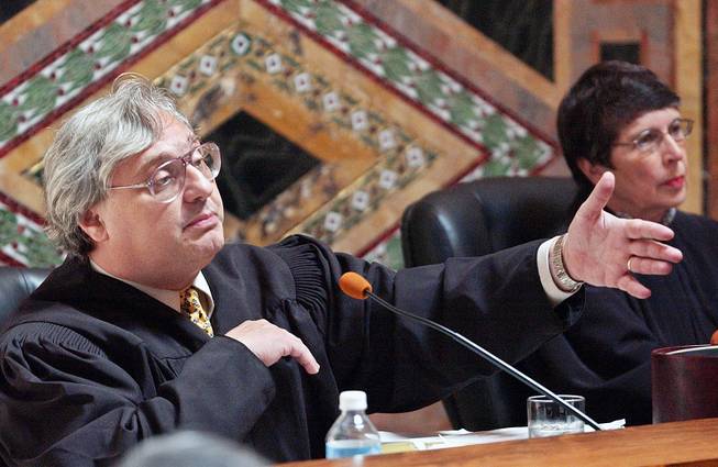 Judge Alex Kozinski of the 9th U.S. Circuit Court of Appeals gestures as Chief Judge Mary Schroeder looks on in San Francisco, Sept. 22, 2003. 